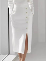 White button-up skirt with a high slit on a plain background