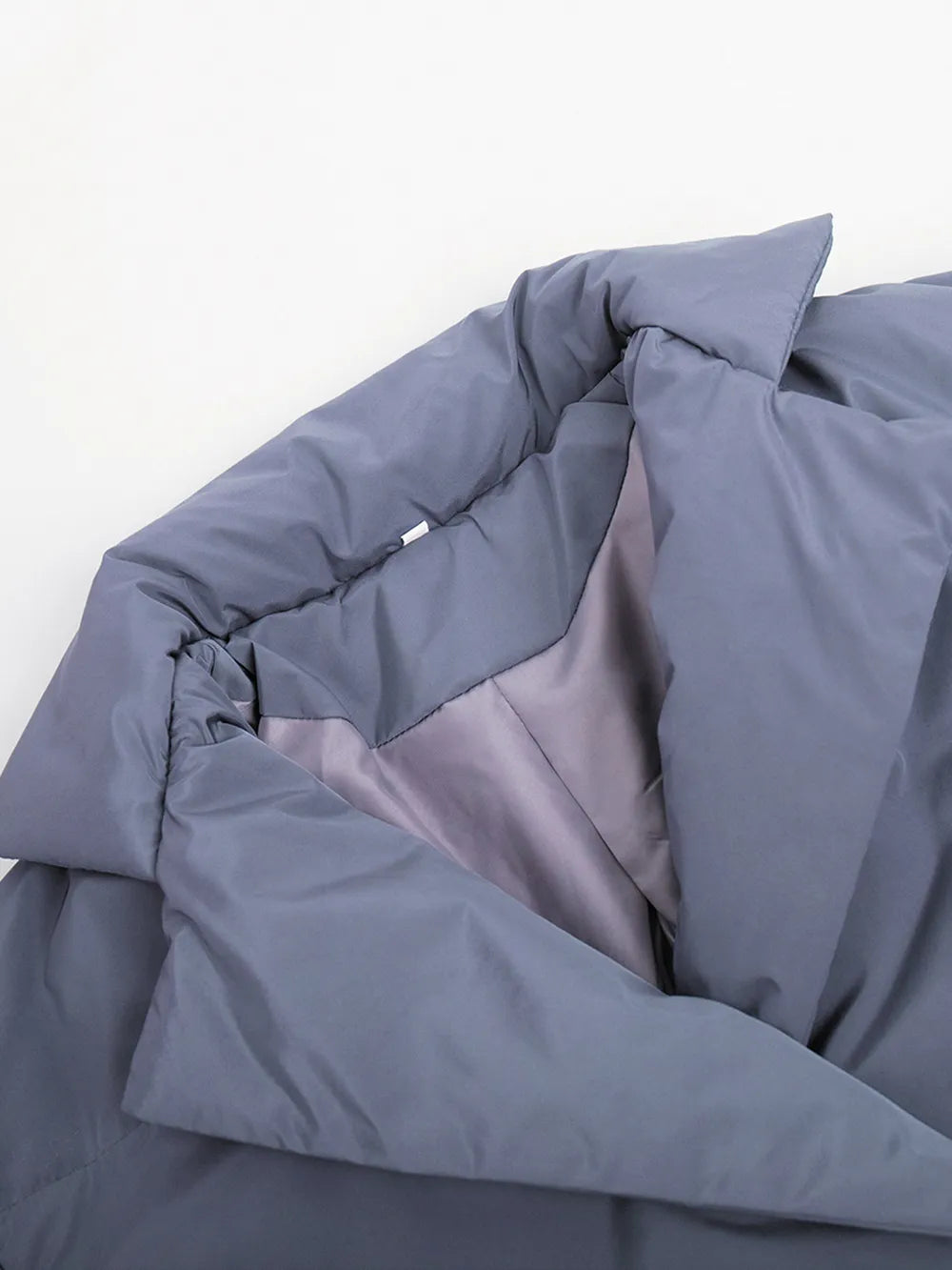 Folded gray comforter on a white background