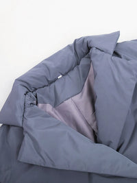 Folded gray comforter on a white background