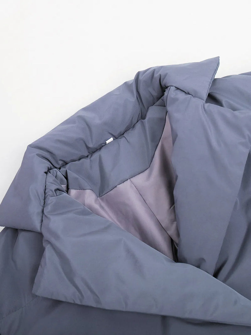 Folded gray comforter on a white background