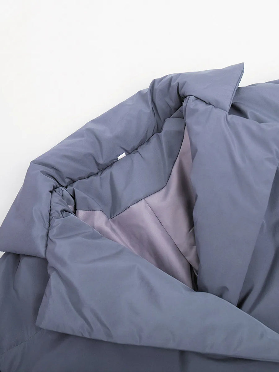 Folded gray comforter on a white background