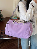 Person holding a purple bag indoors with a neutral background