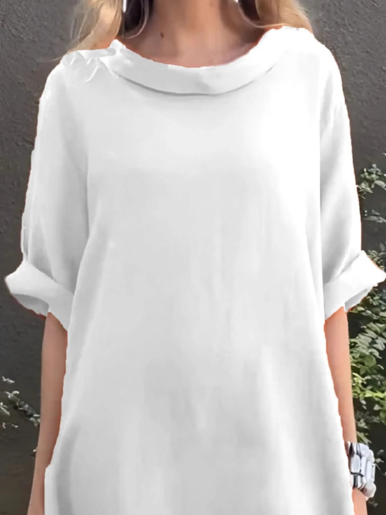 White dress worn by a person against a gray background