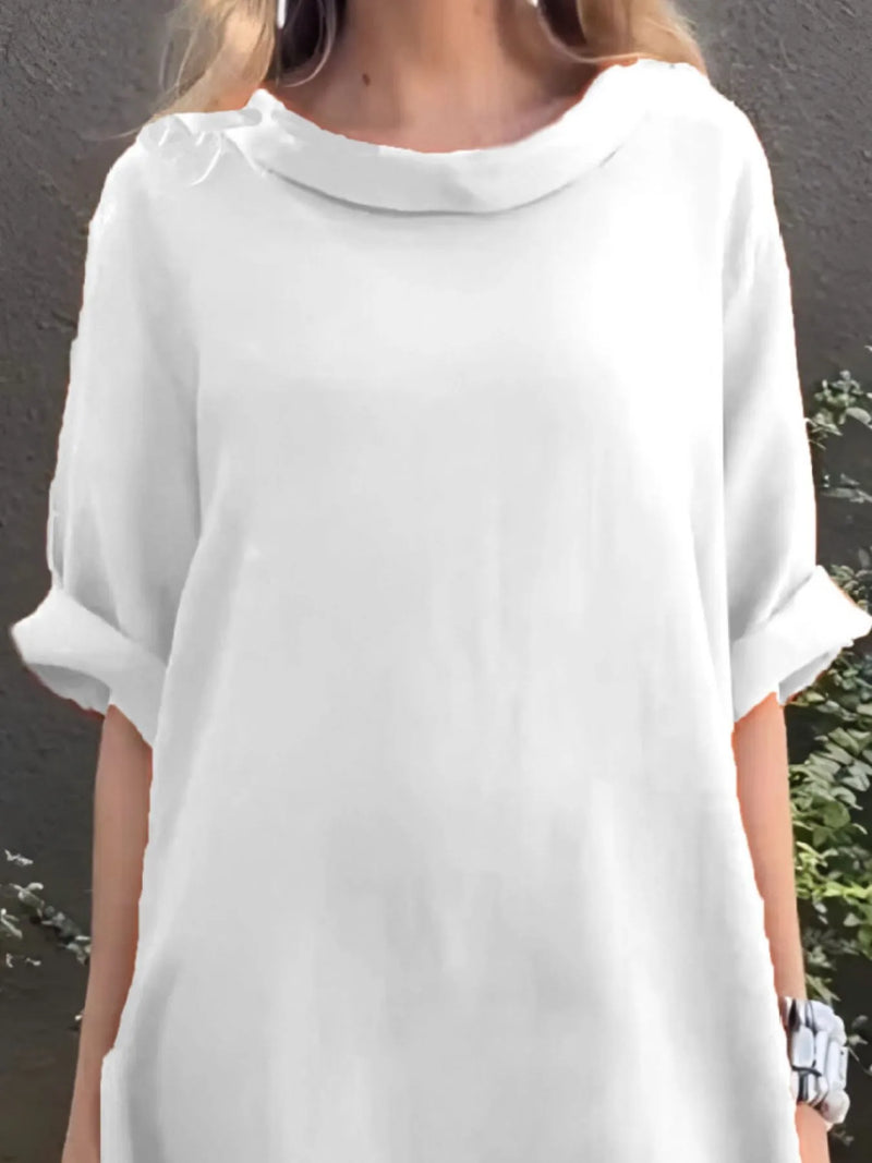 White dress worn by a person against a gray background