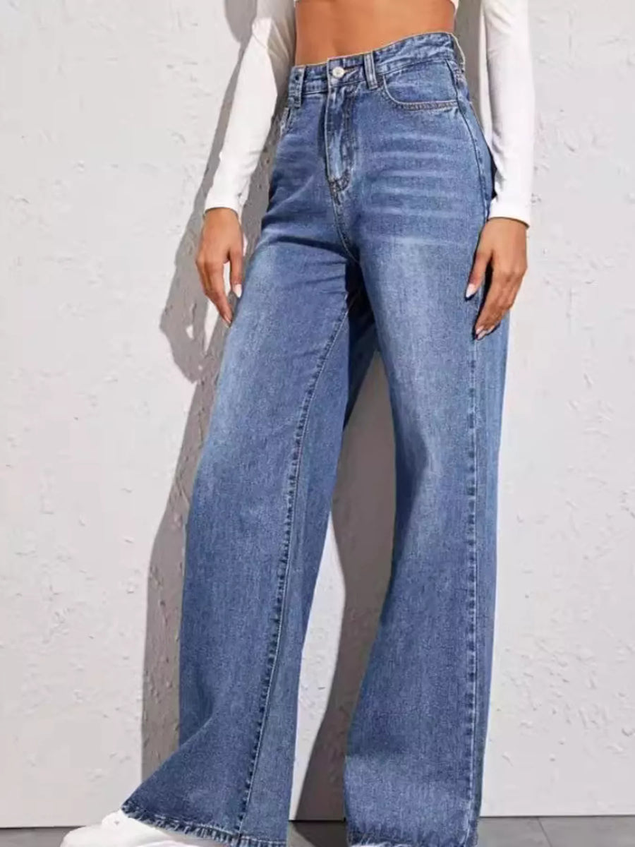 Person wearing blue jeans against a white background