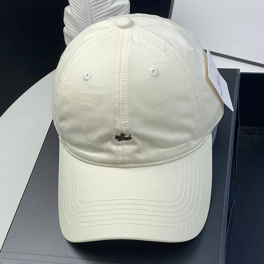 Beige cap with a small stain on a black surface