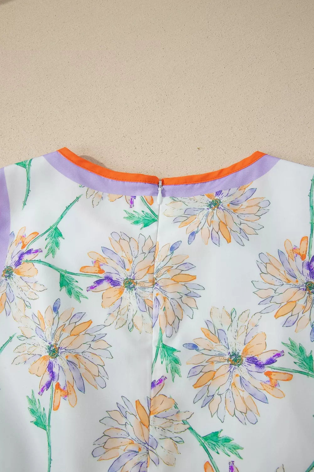 Floral-patterned garment with colorful flowers on a plain background