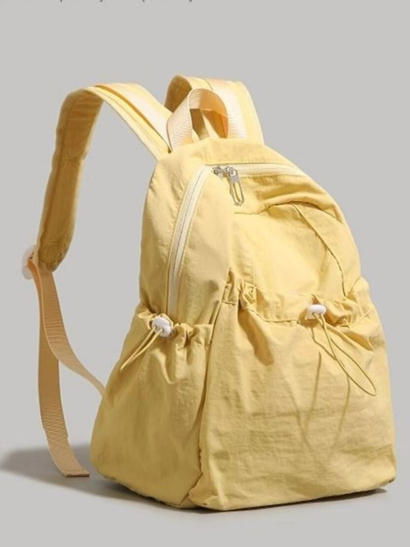 Yellow backpack on a gray background