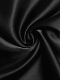 Close-up of black satin fabric with folds