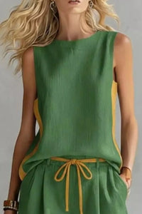 Green sleeveless top with yellow accents on a plain background
