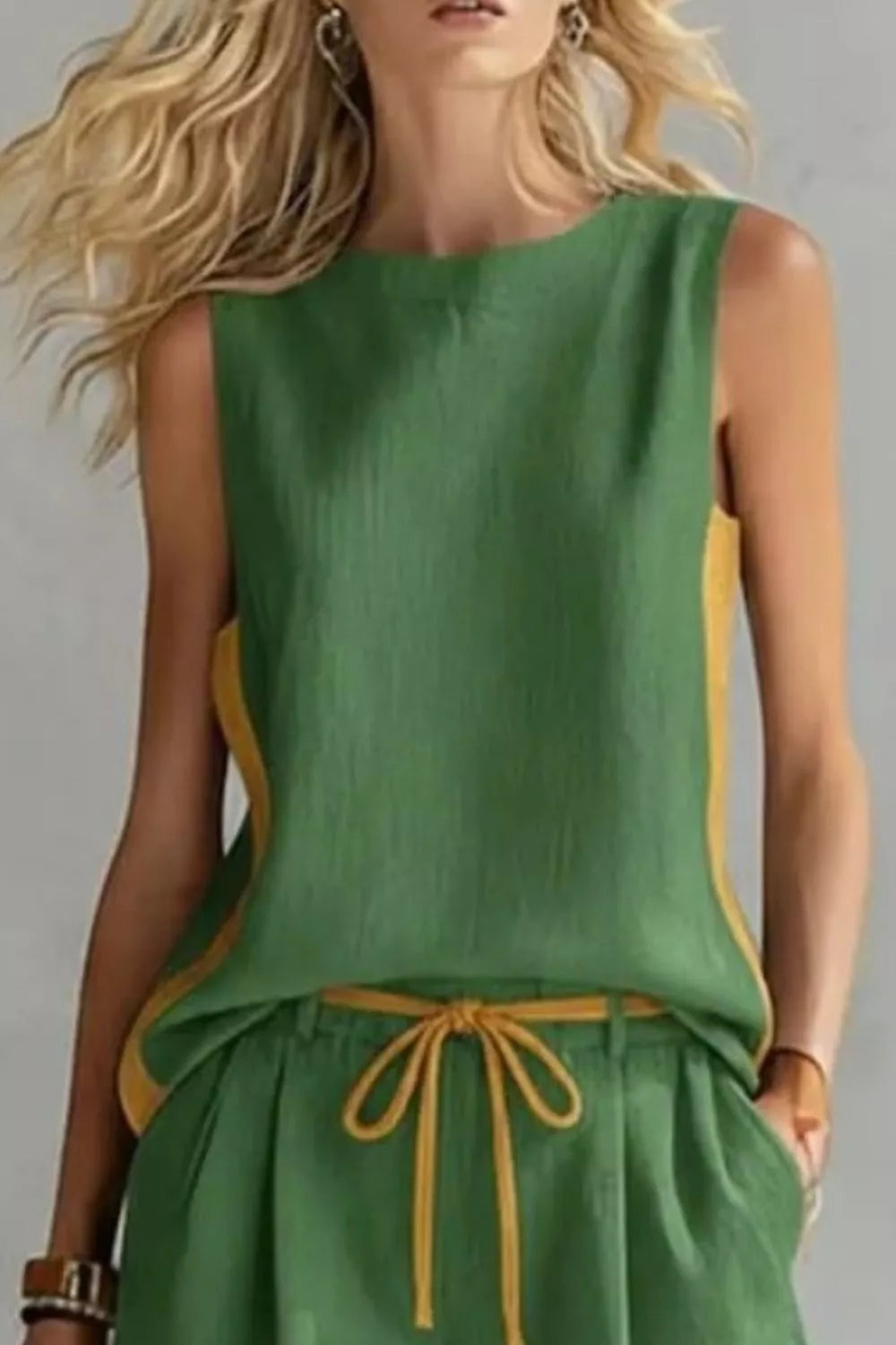 Green sleeveless top with yellow accents on a plain background