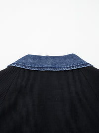 Black sweater with blue denim collar on a white background