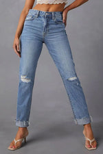 Blue jeans with slight distressing on a gray background