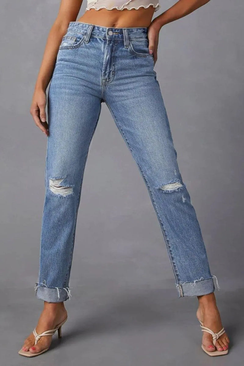 Blue jeans with slight distressing on a gray background