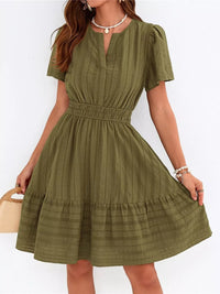 Woman wearing a green dress with a white background