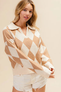 Woman wearing a beige and white patterned sweater with white shorts on a beige background