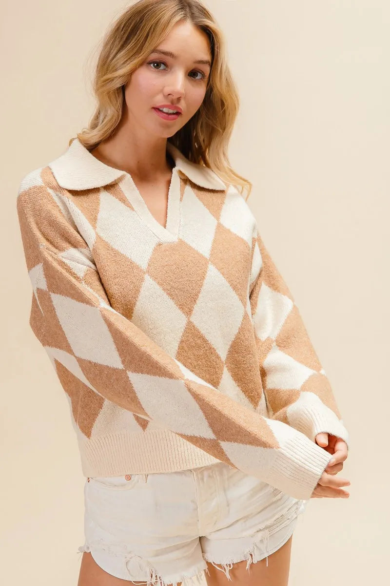 Woman wearing a beige and white patterned sweater with white shorts on a beige background