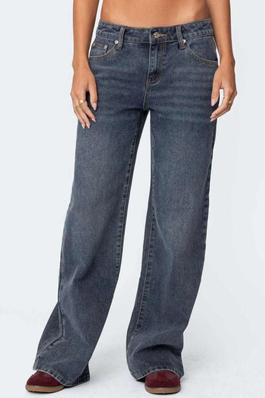 Blue jeans worn by a person on a white background