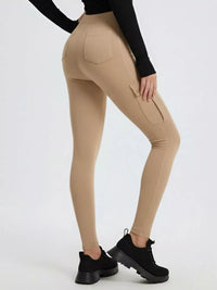 Beige leggings worn by a person on a white background