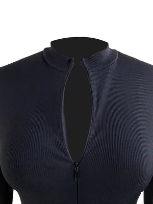 Black ribbed knit top on a mannequin with a plunging neckline and zipper detail.
