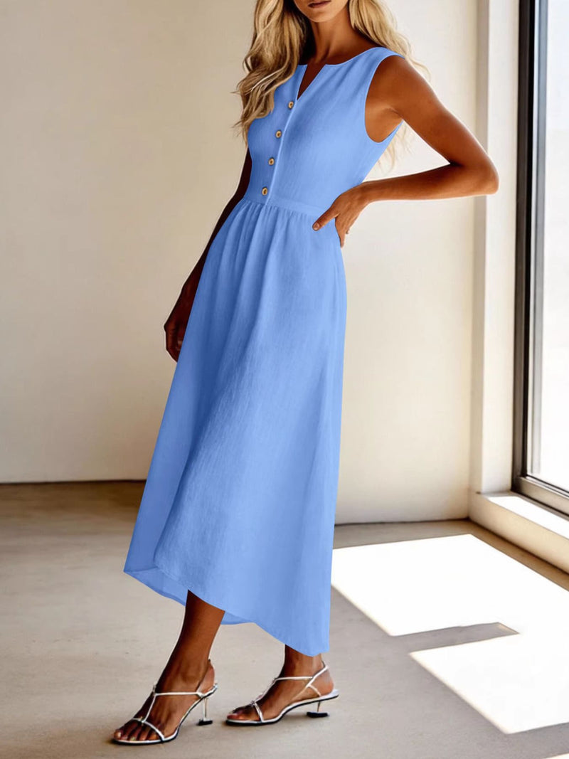 Woman wearing a light blue dress in a room with a window.