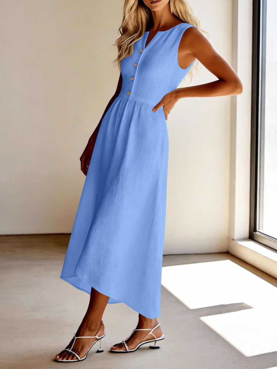 Woman wearing a light blue dress in a room with a window.