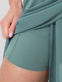 Teal athletic shorts with a close-up of the fabric on a white background