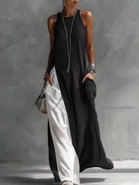 Person wearing a black and white dress against a gray background