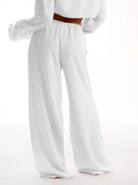 White wide-leg pants worn by a person on a white background