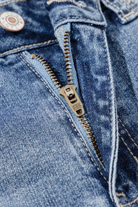 Close-up of a blue denim jacket with a zipper