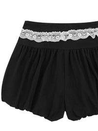 Black shorts with lace waistband on a white background