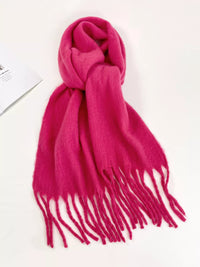 Pink scarf with tassels on a white background