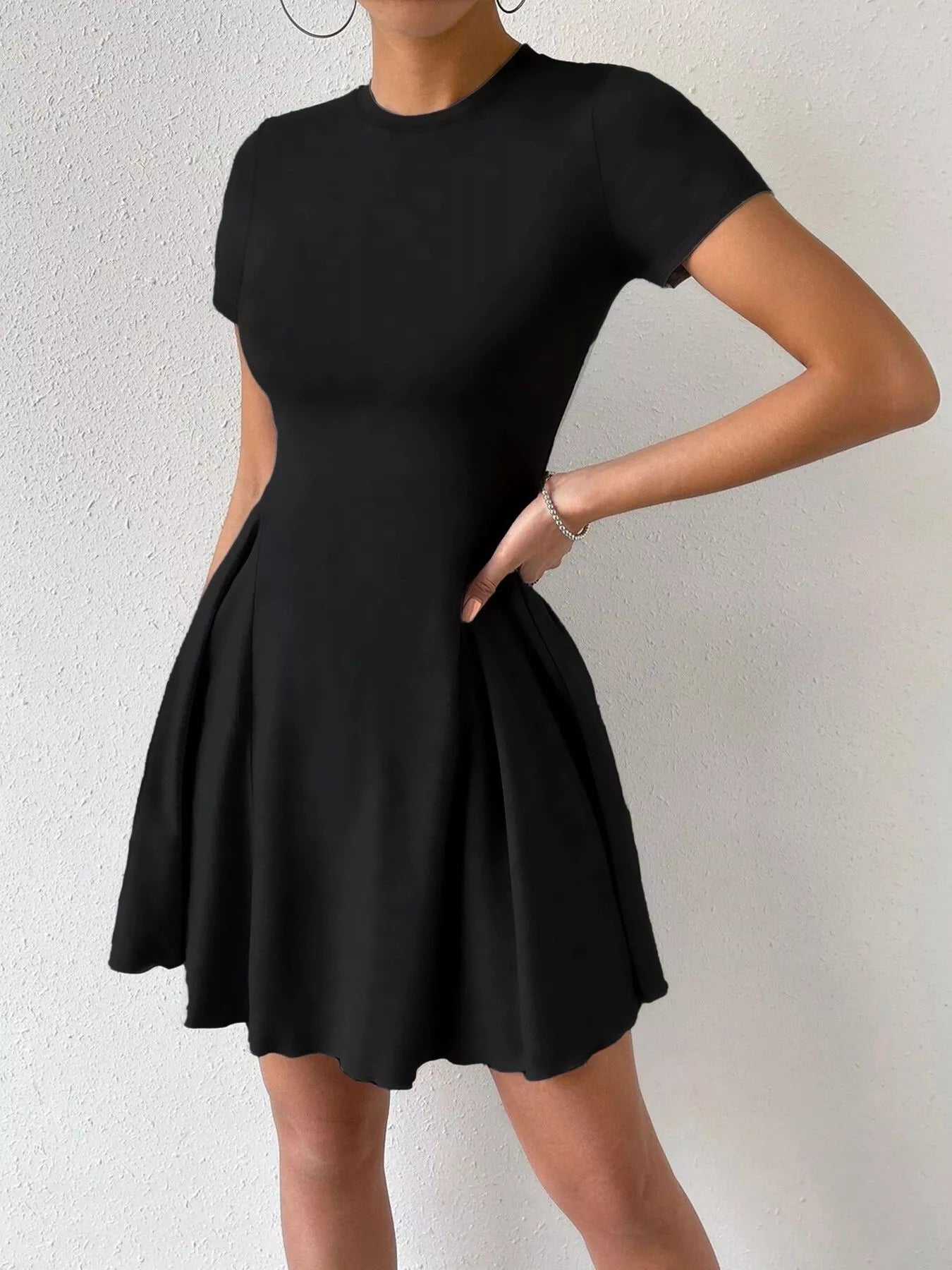Black dress worn by a person on a white background