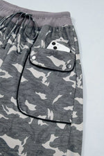 Gray camouflage pants with a pocket on a light gray background
