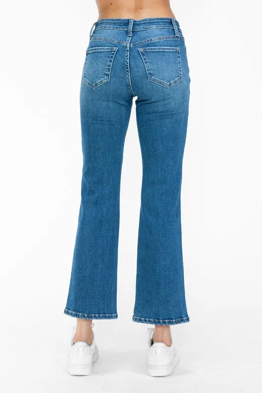 Blue jeans worn by a person on a white background