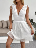 Woman wearing a white dress in a living room setting