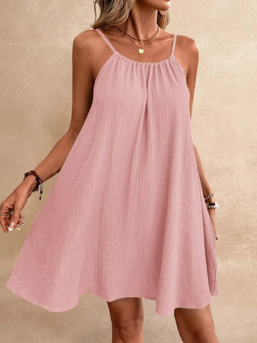 Pink dress worn by a person on a beige background
