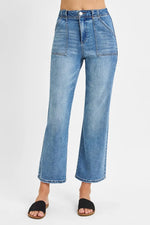 Blue jeans worn by a person on a white background