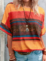 Person wearing a colorful striped shirt with a pendant necklace against a neutral background
