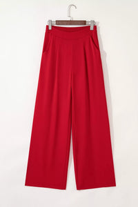 Red pants on a hanger against a white background