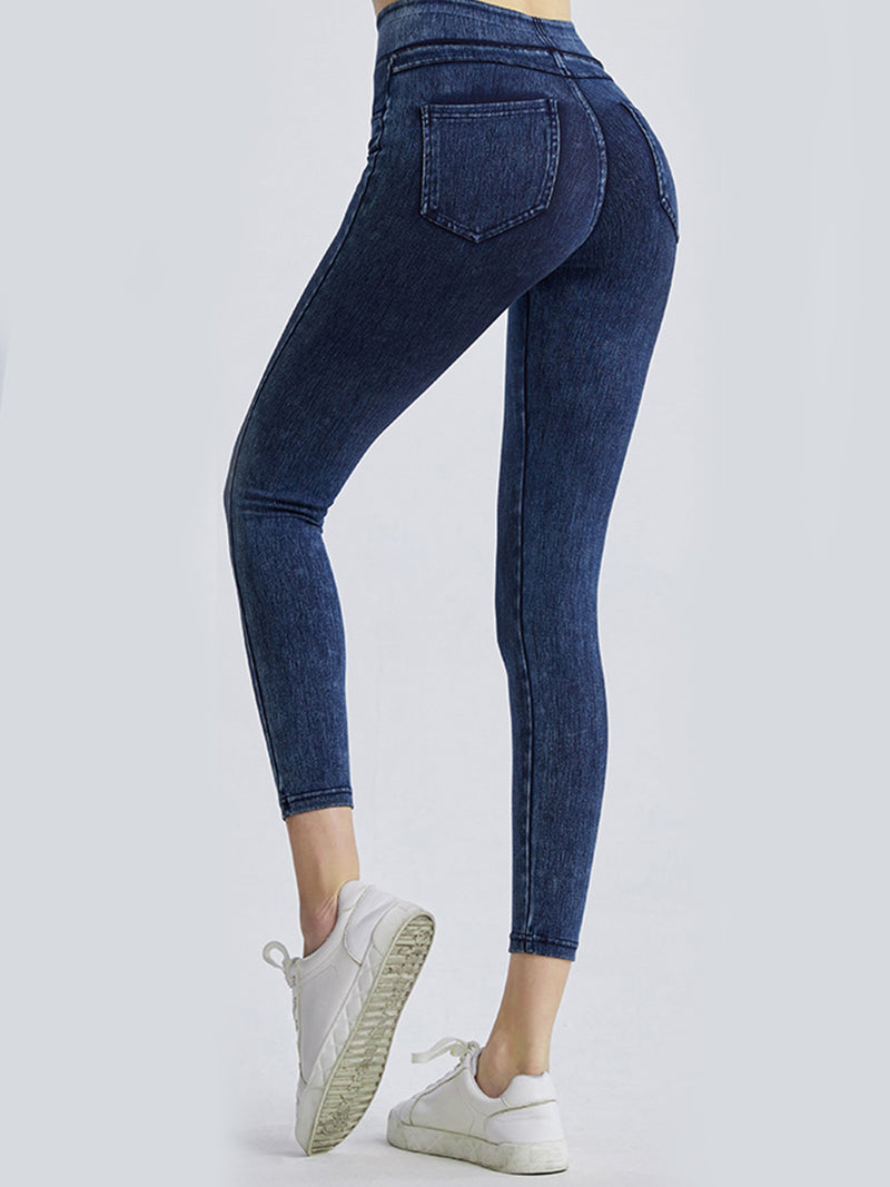 Blue jeans worn by a person on a white background