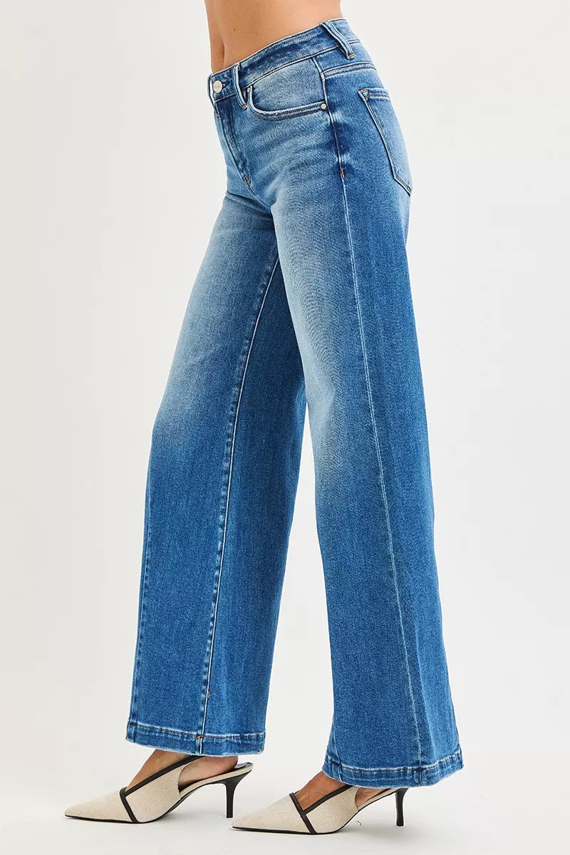 Blue jeans worn by a person on a light gray background