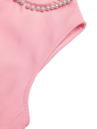 Pink swimsuit with pearl details on a white background