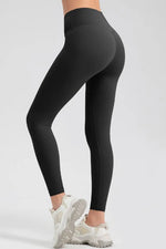 Black leggings worn by a person on a light gray background