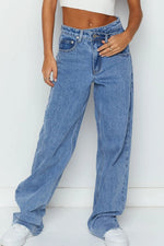 Person wearing blue jeans against a white background