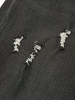 Close-up of a textured black surface with white embroidered patterns.