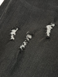 Close-up of a textured black surface with white embroidered patterns.