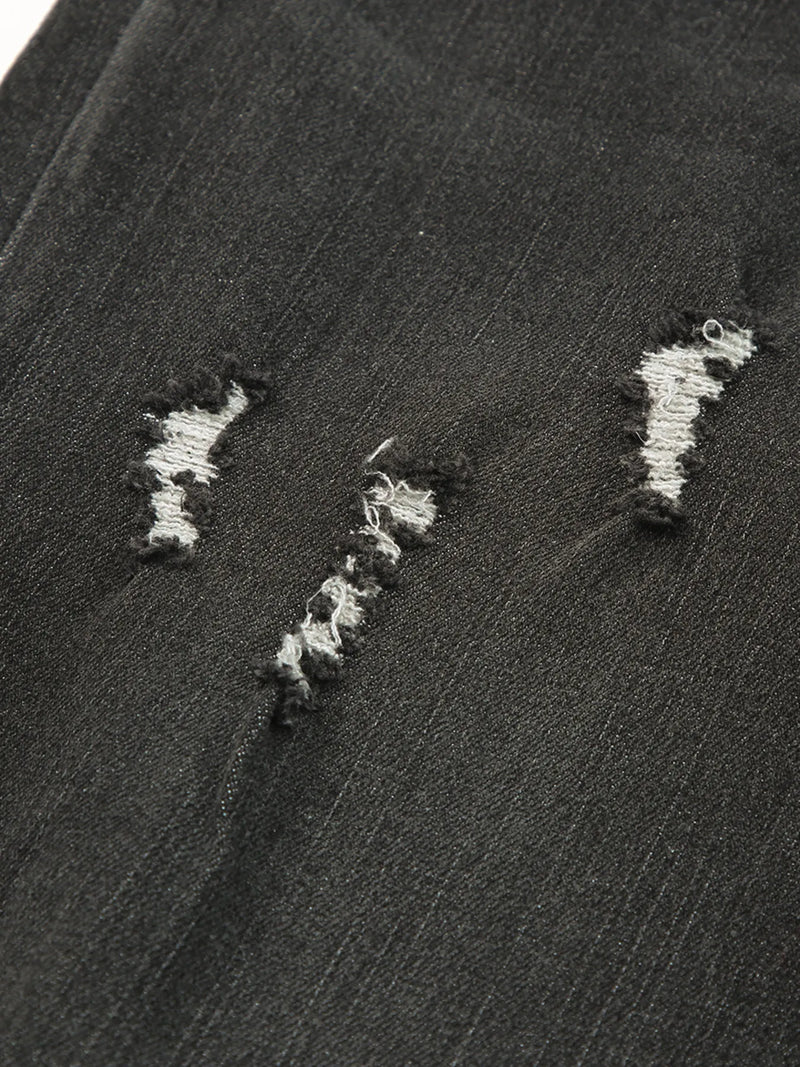 Close-up of a textured black surface with white embroidered patterns.