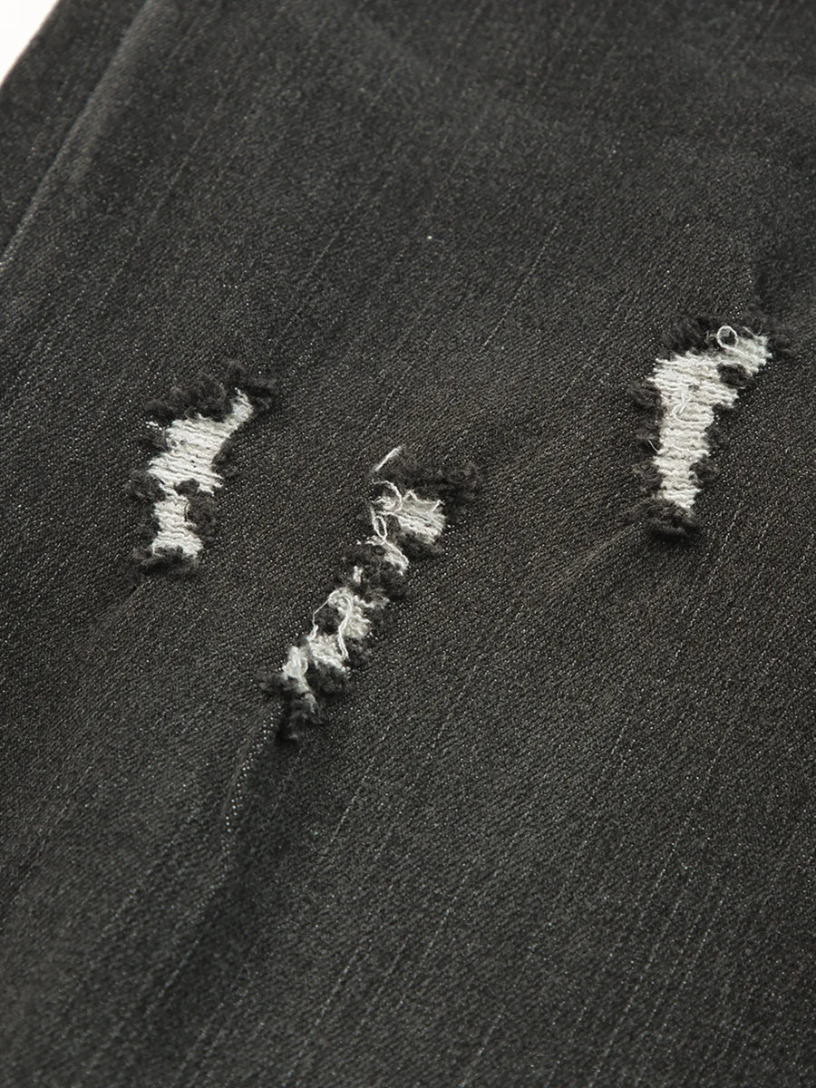 Close-up of a textured black surface with white embroidered patterns.