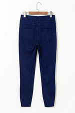 Blue jeans on a hanger against a white background
